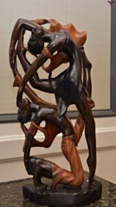 Two bodies, one heartbeat—carved in flowing hardwood to celebrate balance, trust, and the rhythm of our roots.