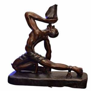 "Haitian wooden sculpture of man blowing conch shell – Soufle Libète"