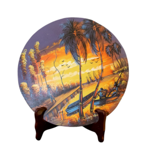 “Hand-painted Haitian sunset plate with palm trees and fishermen in glowing orange and gold hues”